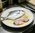 Fresh whole fish with silvery-blue skin on ice